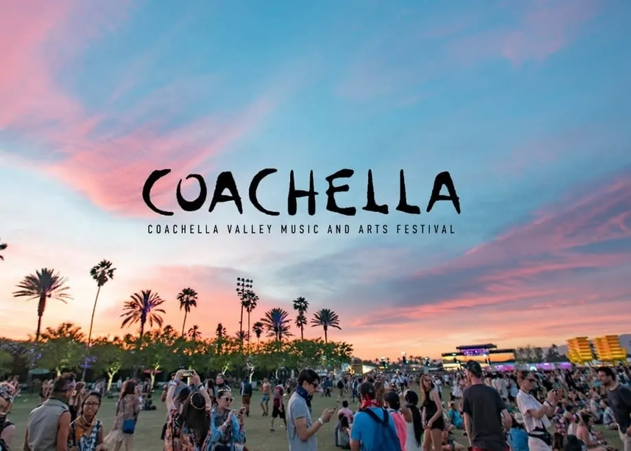 A festival attendee holding a phone showing the Coachella Coin section of the app.