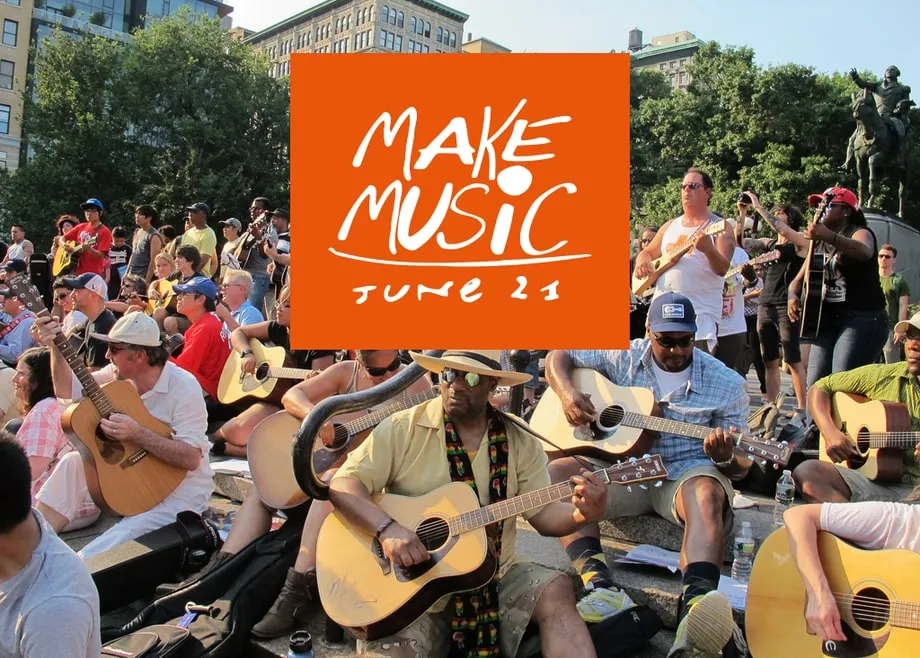 A large group of guitarists playing together in a city park on Make Music Day.